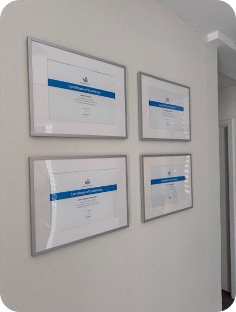 Framed Certus Certificate of Excellence awards on the wall at Scandic IT