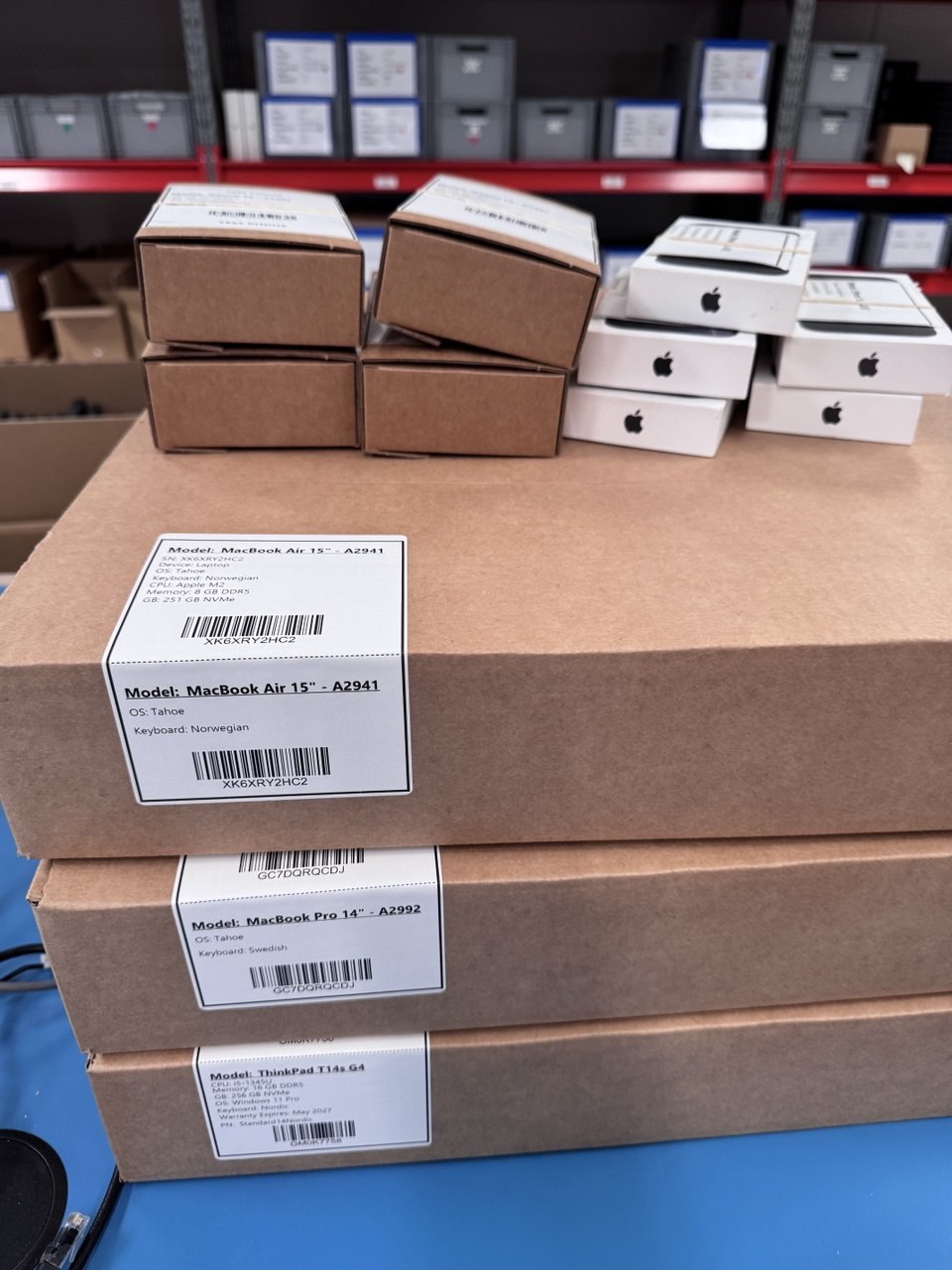 Refurbished laptops, labelled and boxed, ready for resale at Scandic IT